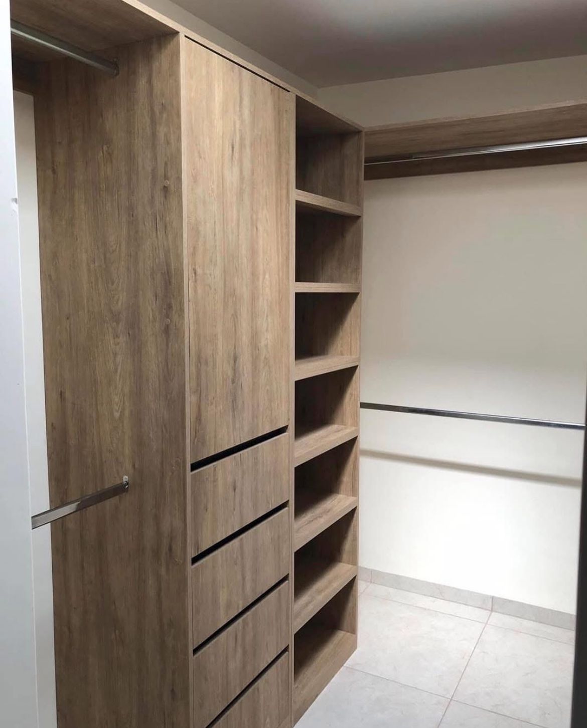 Vestidor walk-in en roble claro con cajones y repisas