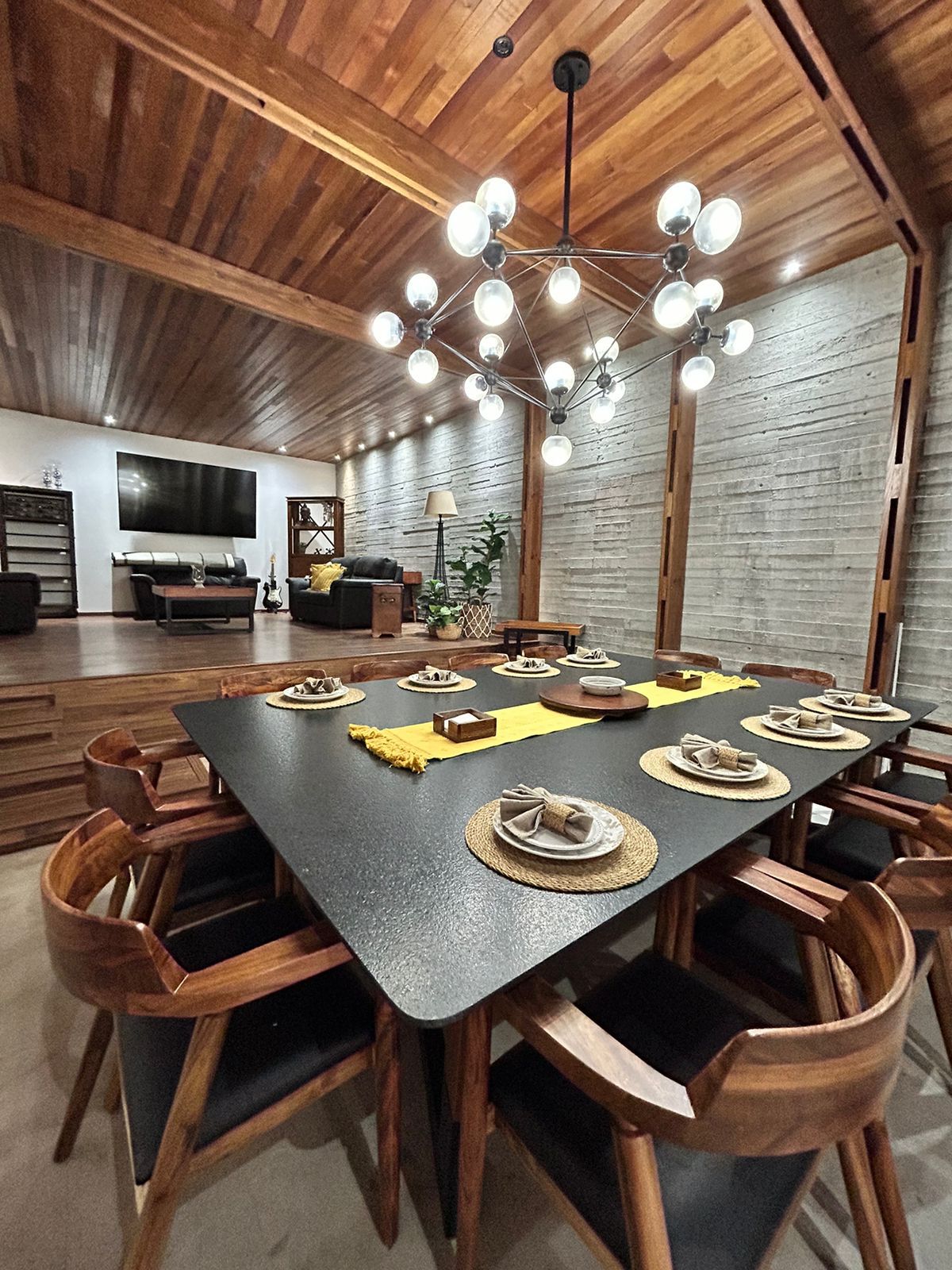 Comedor con mesa de piedra negra para diez con candil escultórico